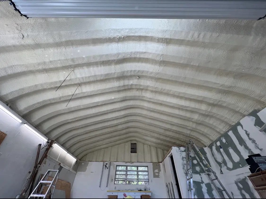 Spray polyurethane foam applied to the underside of a metal roof deck in Rushville